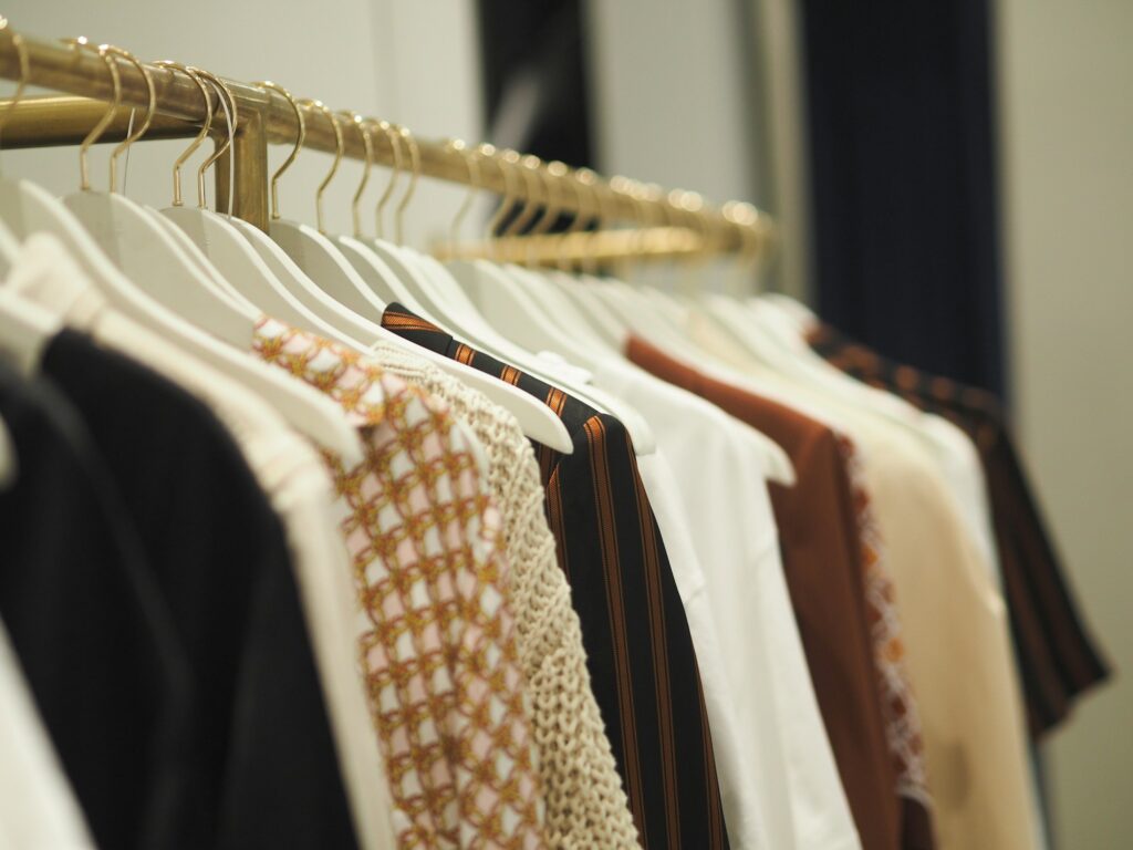 Colourful clothes handing on a clothes rack.